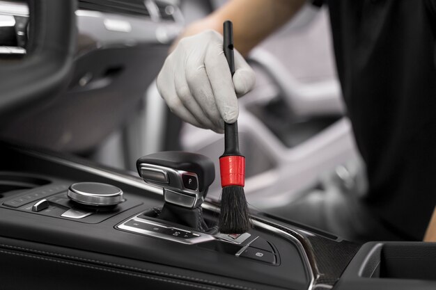 A person using a brush during auto detailing services in Irvine