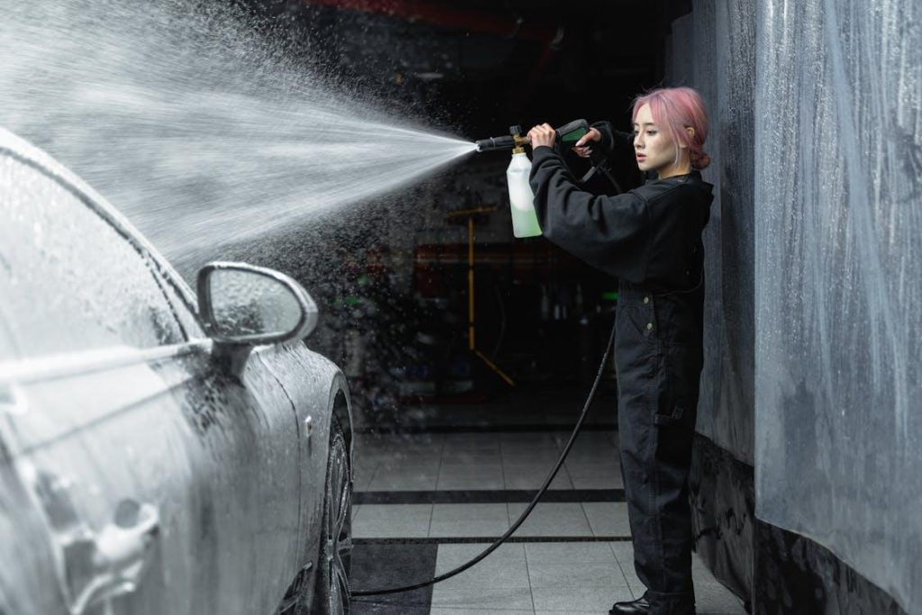 Mobile car detailing services provider washing a car