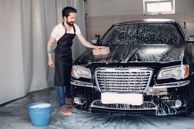 A person washing a car during car detailing services in Irvine