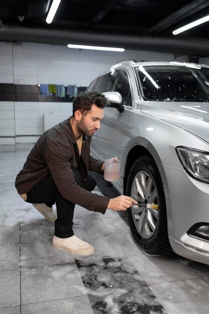 A man painting tires during auto detailing services in Irvine