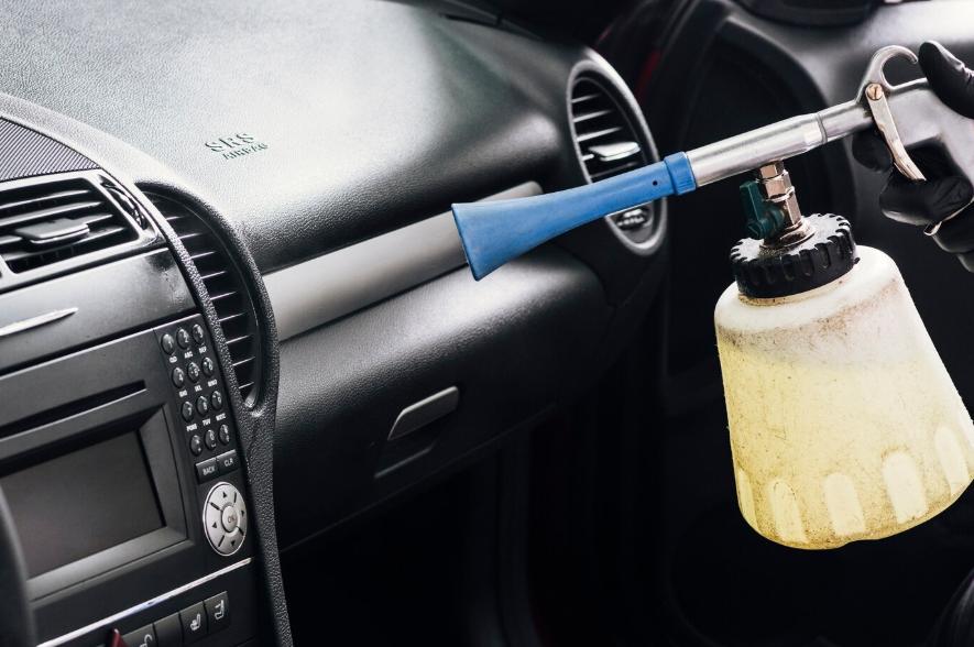 a person cleaning car interior